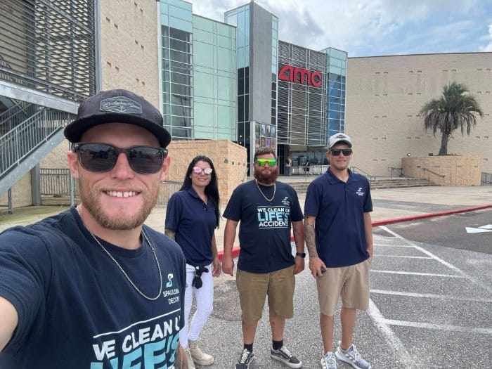 Spaulding Decon Daytona Beach team members standing outside a local AMC theater property