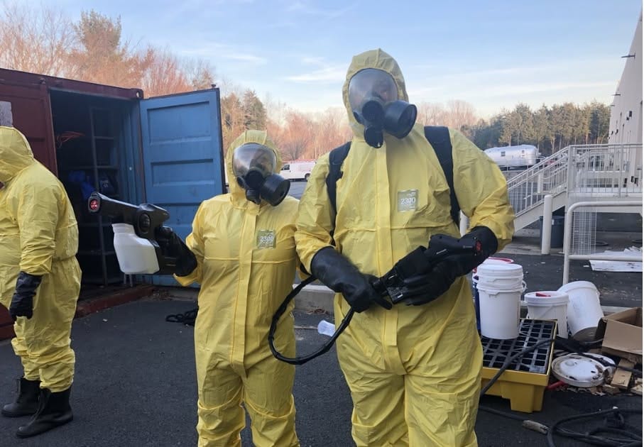 Spaulding Decon decontamination crew in yellow hazmat suits serving Miami and South Florida