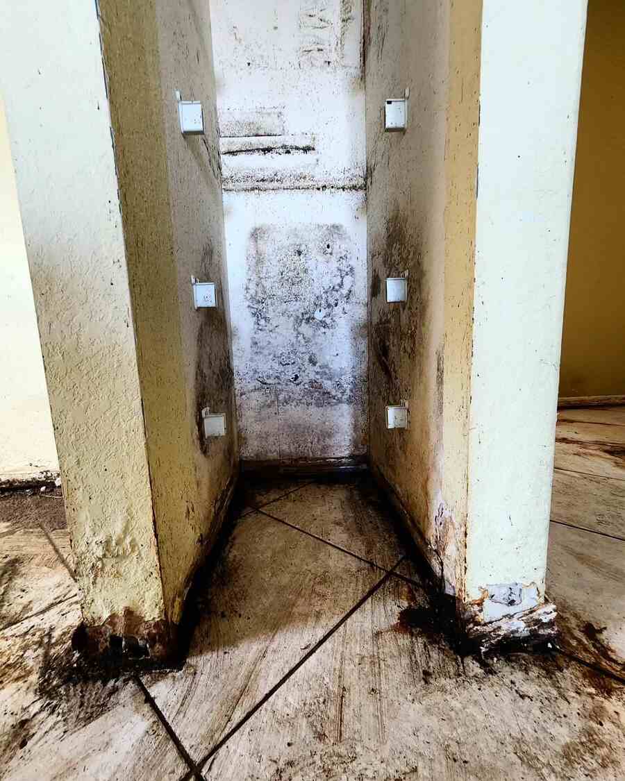 Extensive water damage and staining on walls and flooring before Spaulding Decon Miami water damage restoration